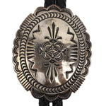 Thomas Curtis (1942-2013) - Navajo - Sterling Silver and Leather Bolo Tie with Stamped Design c. 1960-70s, 3.125" x 2.5" bolo